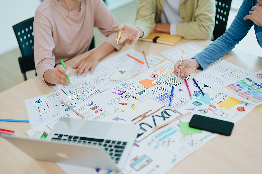 Group of asian creative team programing designers participate in all phases of the UX UI design